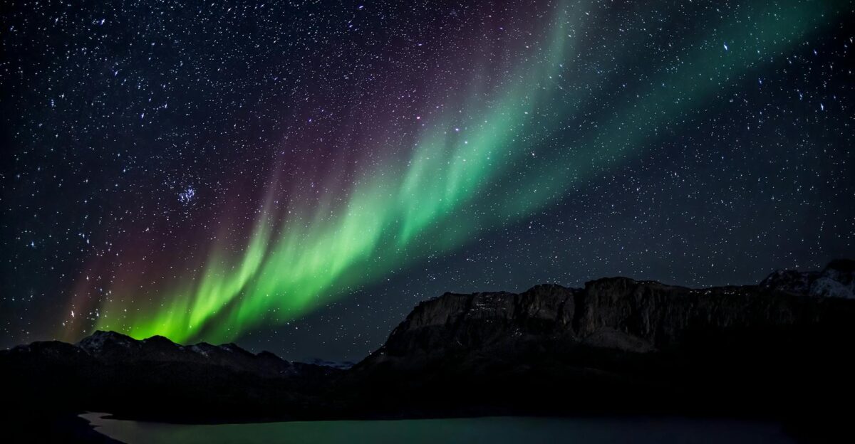 Mesmerizing aurora borealis illuminating the night sky over a serene landscape capturing nature s beauty