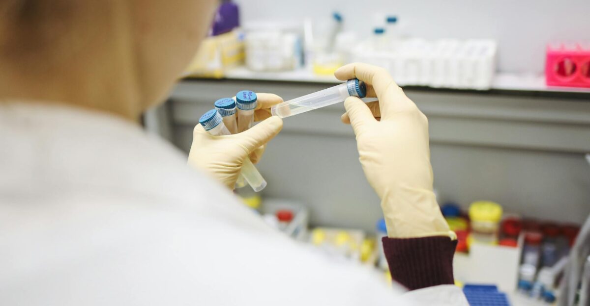 Scientist examining test tubes in a laboratory setting wearing protective gloves