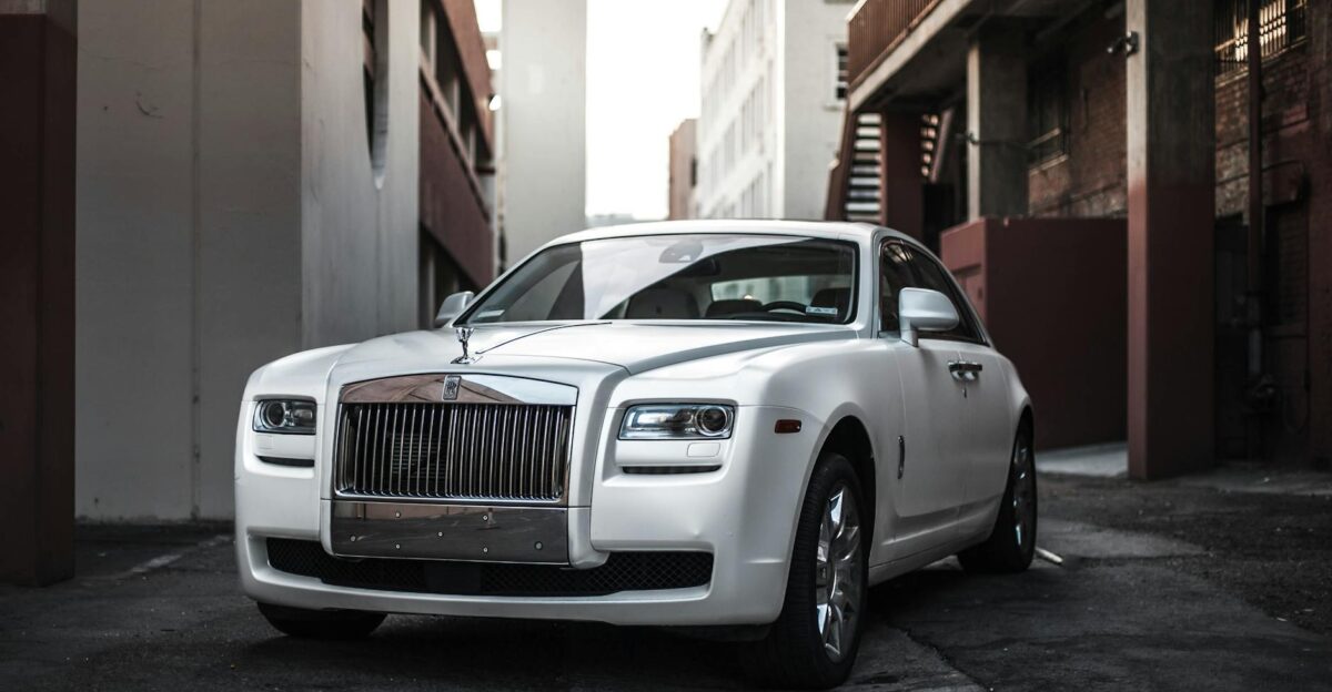 Elegant white luxury car parked in an urban alley exuding sophistication and style