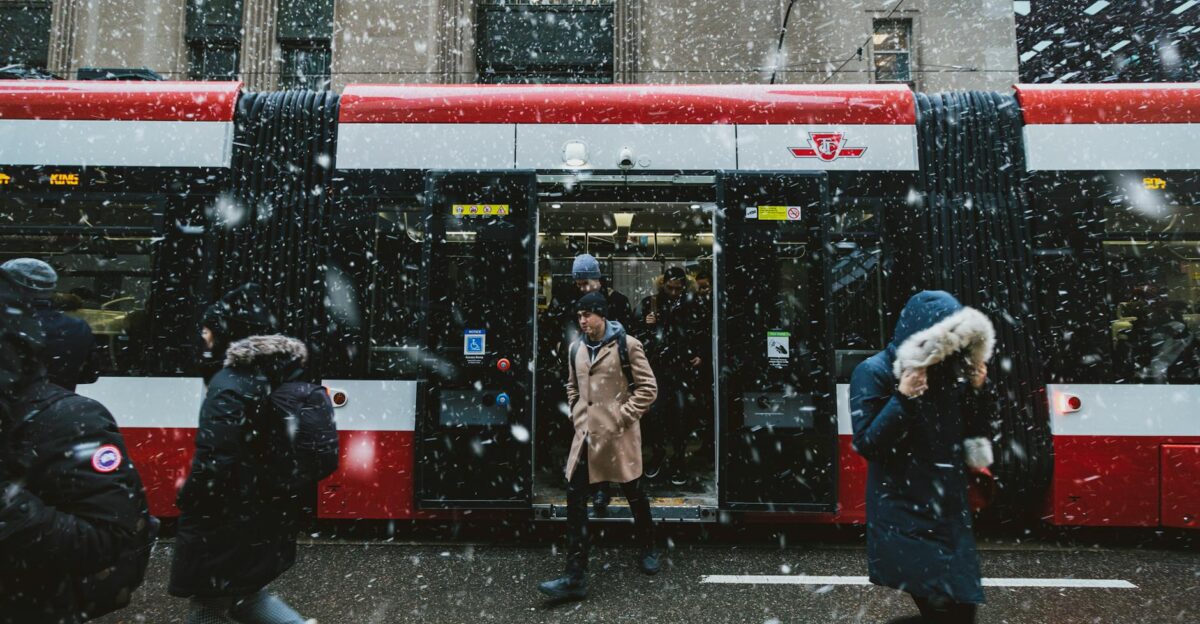 Commuters navigate a snowstorm outside a TTC streetcar in downtown Toronto