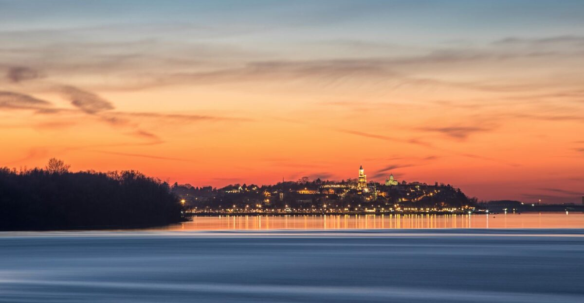 Serene sunrise view of Kalemegdan Fortress reflected on the river in Belgrade Serbia