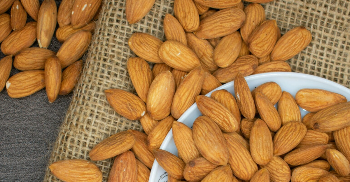 Top view of almonds in a white bowl on a burlap surface, highlighting healthy snacking.