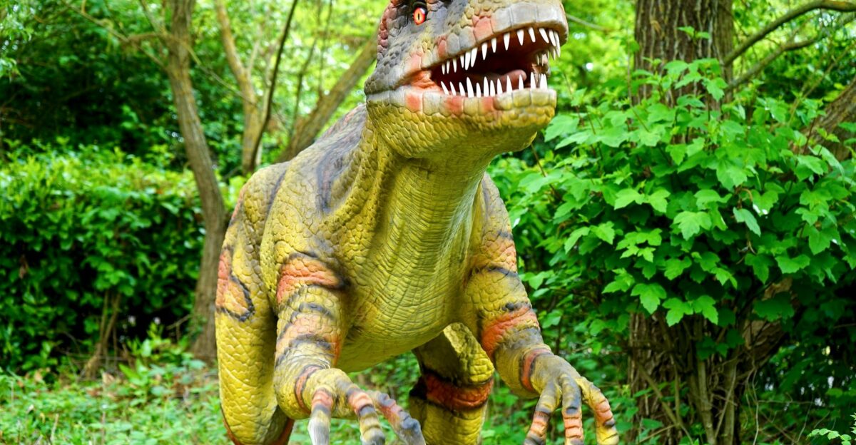 A realistic dinosaur statue in a tranquil forest surrounded by lush greenery and trees