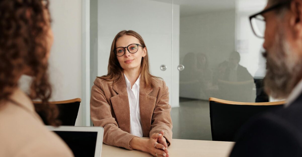 Young woman attending a job interview in a modern office showcasing confidence and professionalism