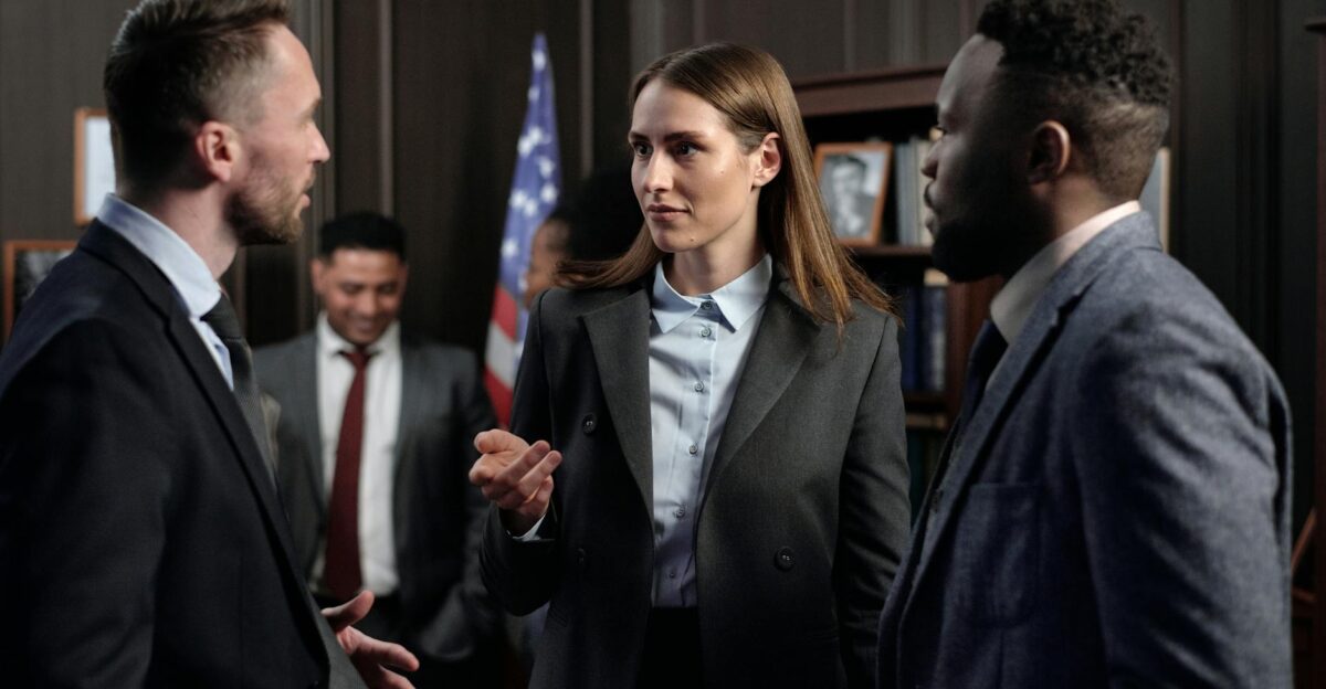 A diverse group of business professionals engaged in a discussion in an office