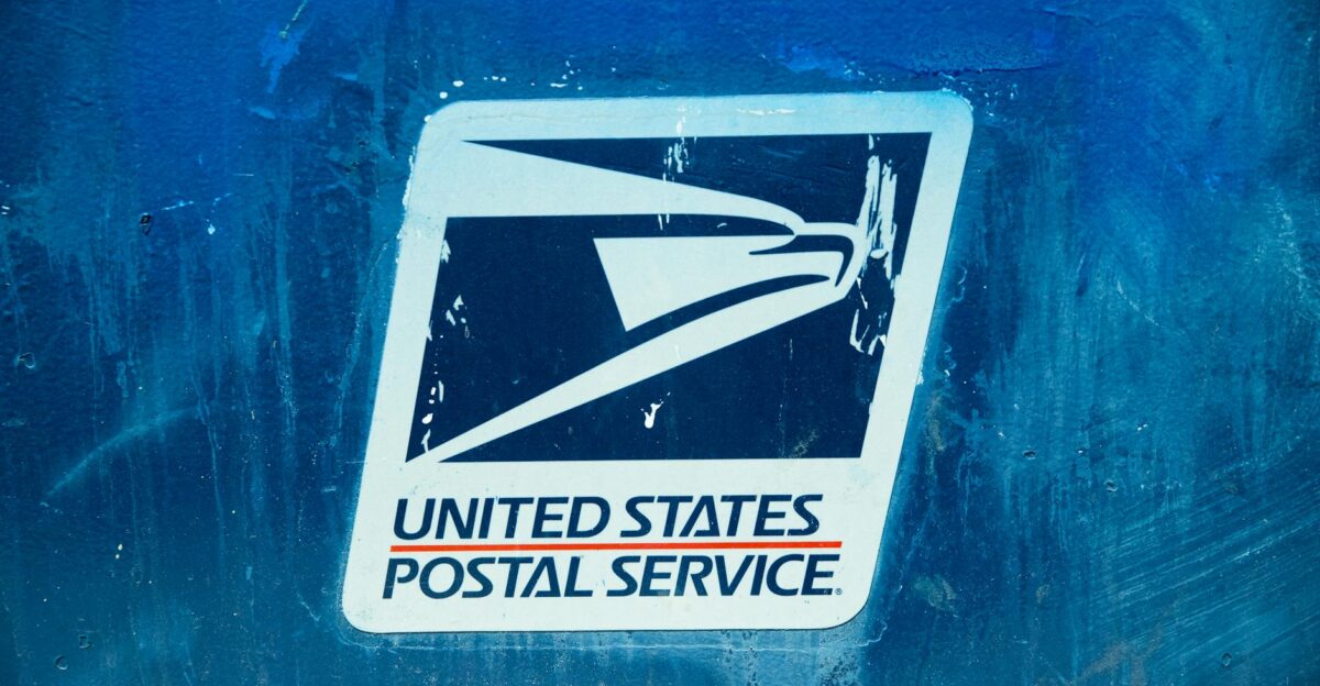 Detailed view of the United States Postal Service logo on a blue background showcasing texture