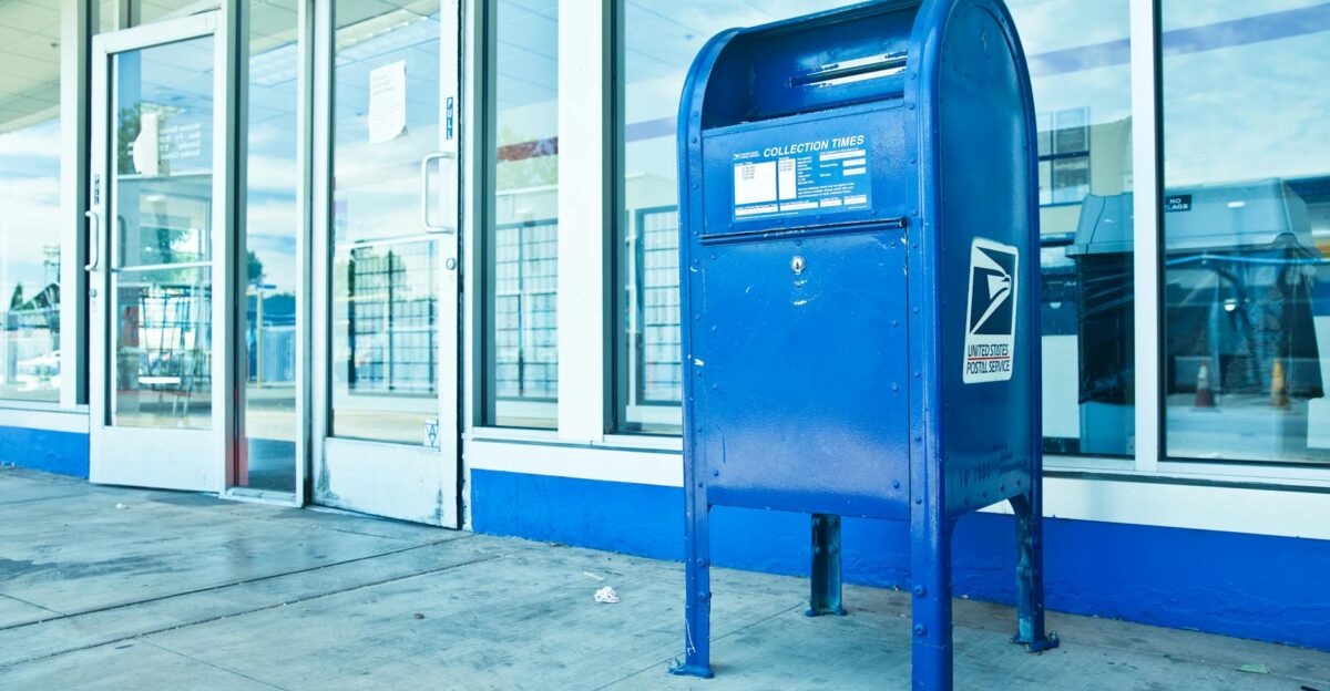 USPS blue mailbox against a post office facade in Los Angeles CA