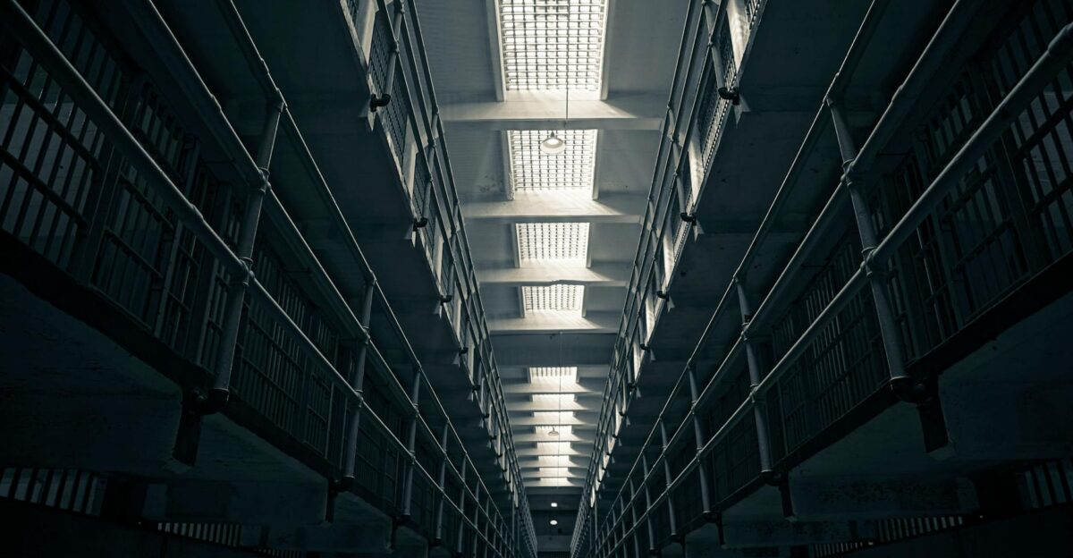A low-angle view of Alcatraz prison cell block showcasing steel railings