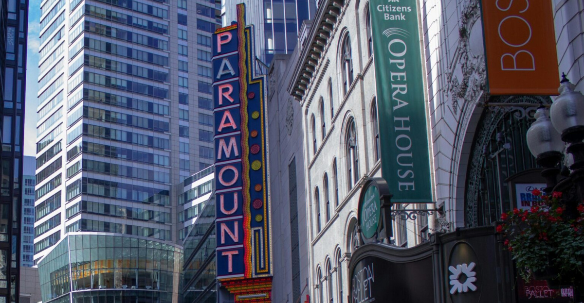 A quiet street in downtown Boston showcasing iconic Paramount marquee and urban architecture.
