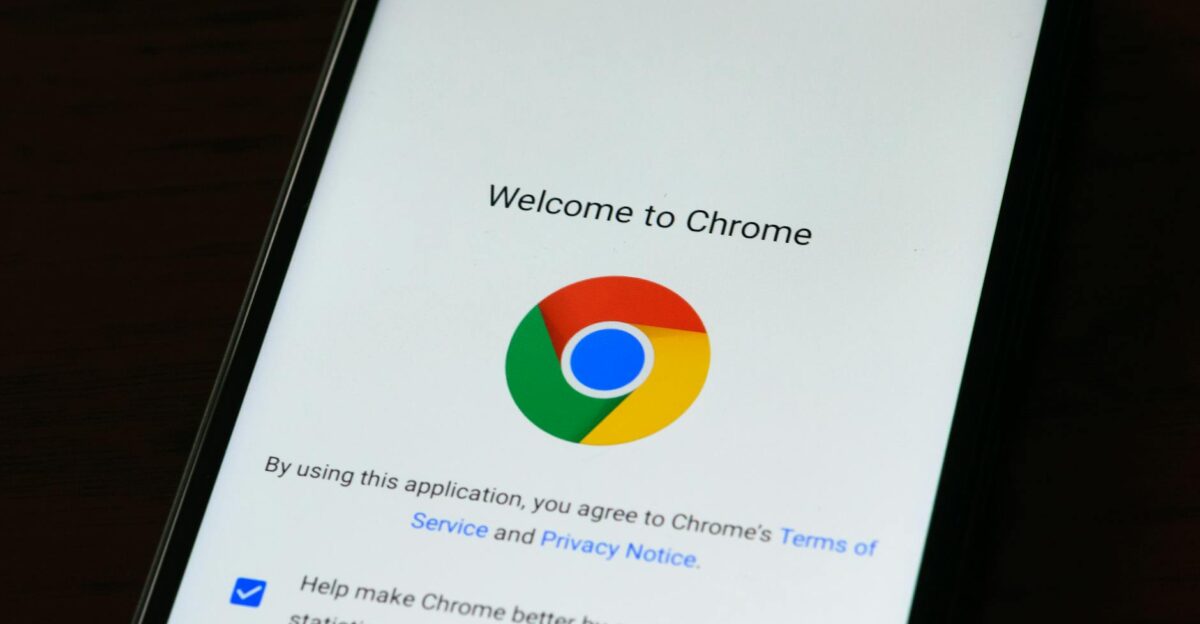 Close-up of smartphone displaying Google Chrome s welcome page and logo