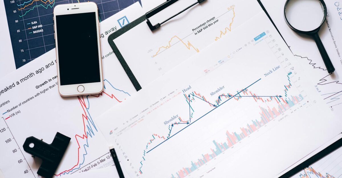 Stock market analysis setup with charts phone magnifier and clipboards