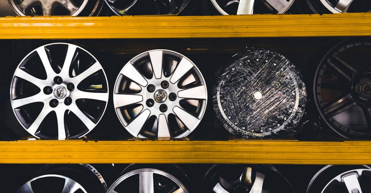 Vertical shot of various car rims displayed on shelves in Malaysia showcasing different designs