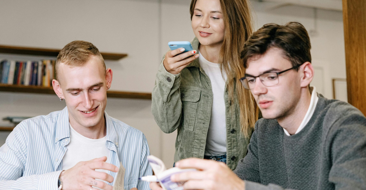 A group of young professionals working together in a modern office setting, showcasing teamwork and creativity.