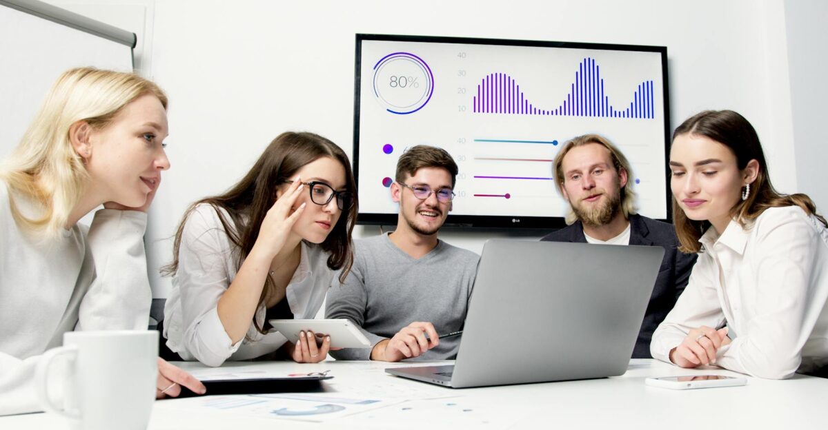 A diverse group of young professionals collaborating in a modern office environment