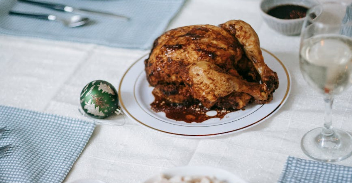 A beautifully set table for a festive holiday meal featuring roast turkey salad and sides
