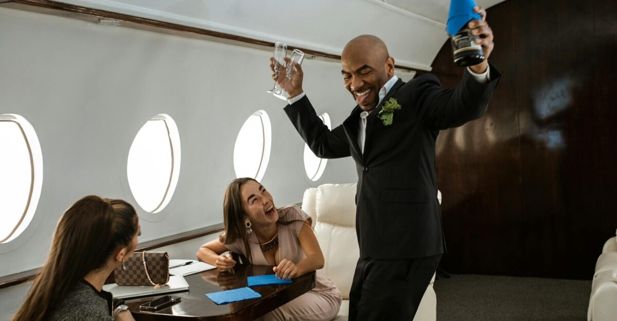 Joyful passengers celebrating with champagne on a private jet