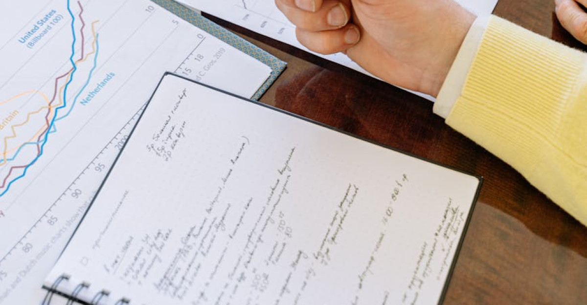 A close-up of businesspeople analyzing financial data and charts during a meeting