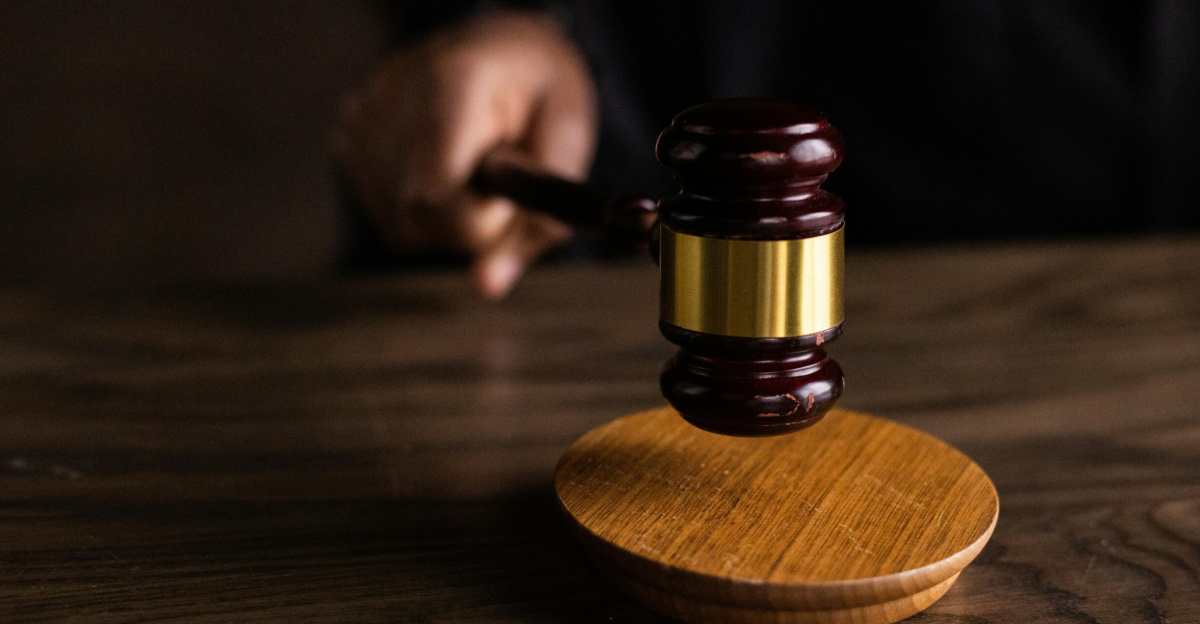 A gavel striking a sound block, symbolizing justice and legal authority in a courtroom setting.