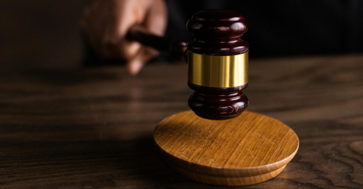 A gavel striking a sound block, symbolizing justice and legal authority in a courtroom setting.