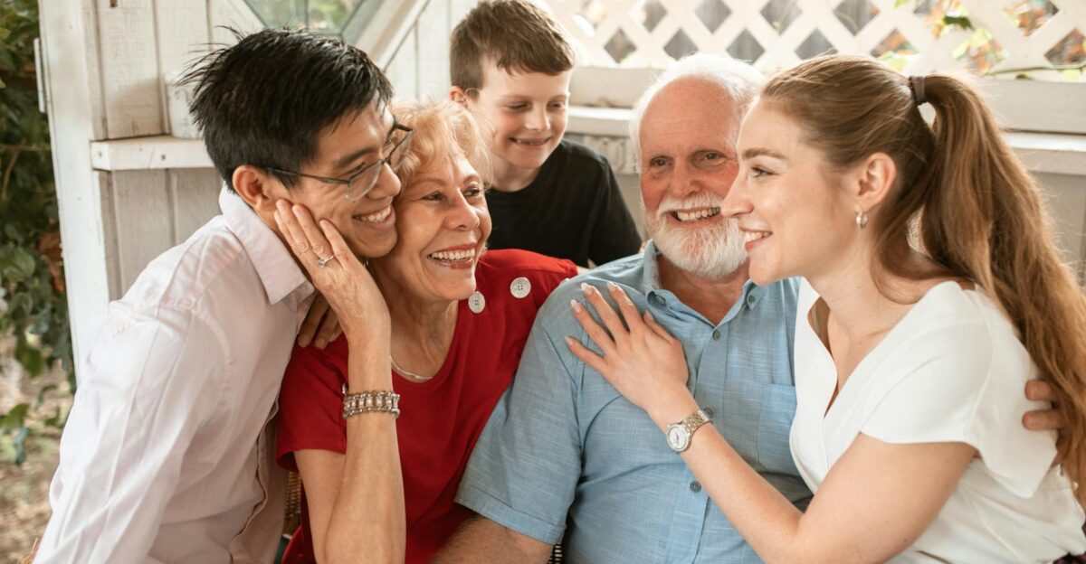 A joyful multi-generational family sharing a warm embrace indoors depicting love and togetherness