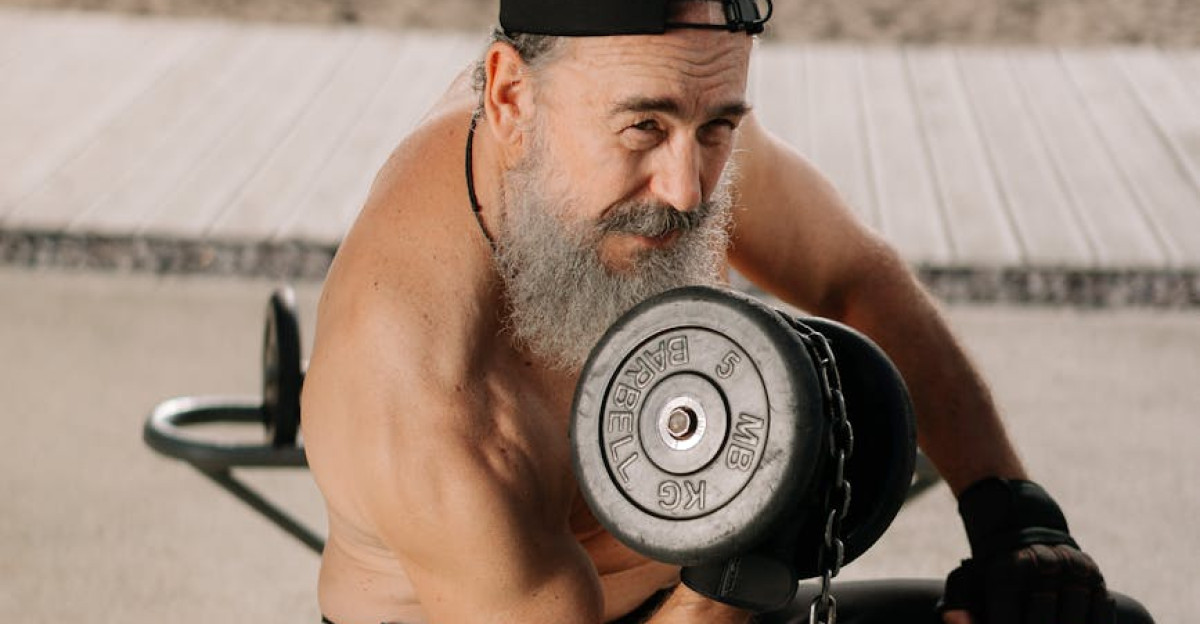 Elderly man lifting weights shirtless in park showcasing fitness lifestyle