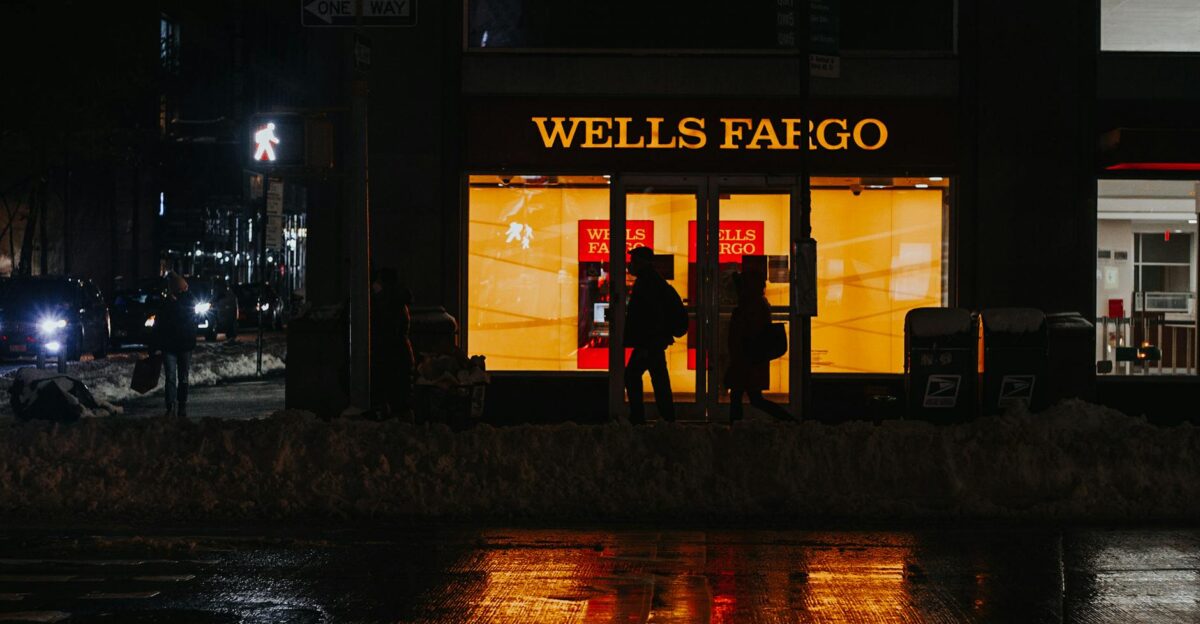 Busy contemporary New York City street with moving cars and walking pedestrians in winter evening