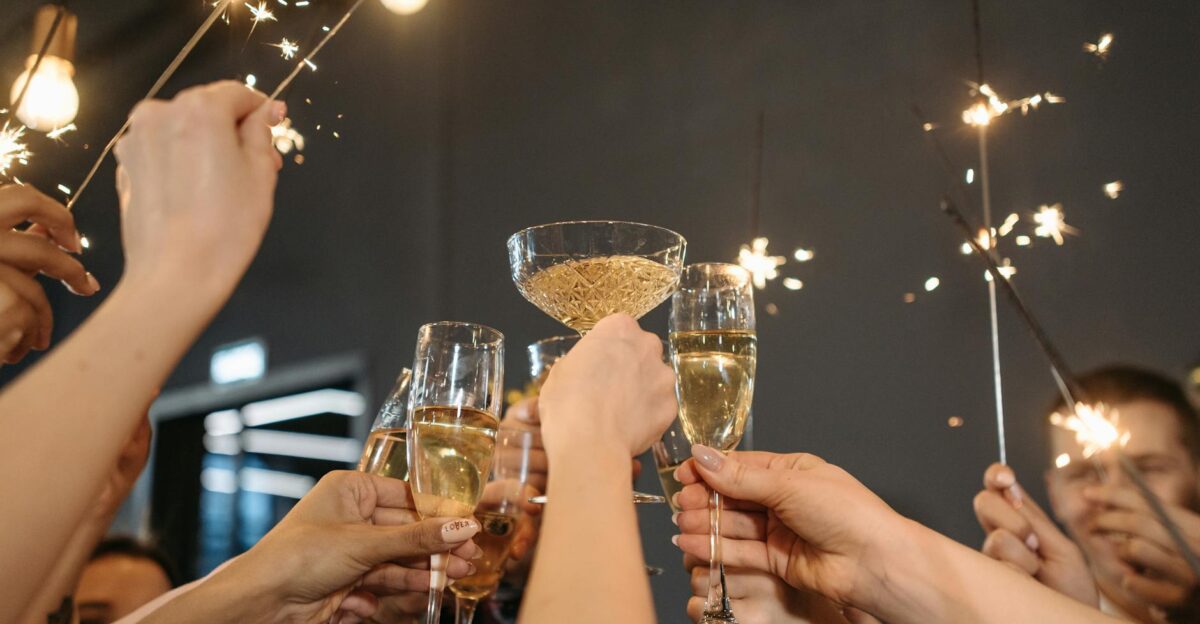 A group of adults celebrating with champagne and sparklers indoors Perfect for festive occasions