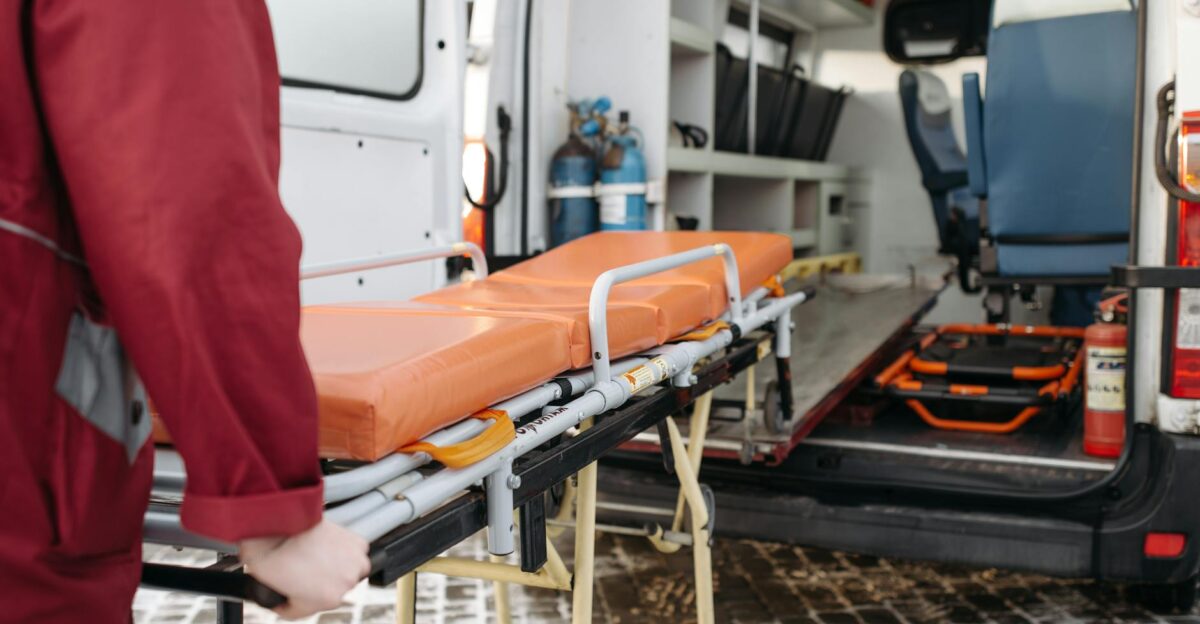 A paramedic loads a stretcher into an ambulance showcasing emergency medical services in action