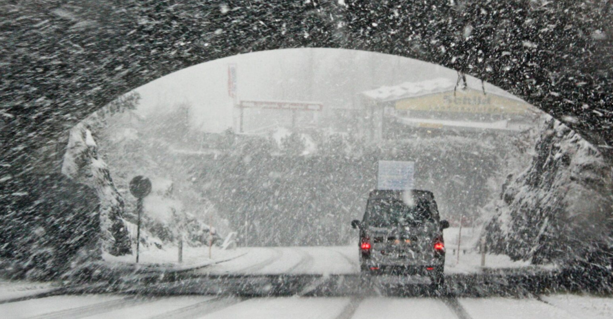 A winter storm covers a Swiss bridge in snow, creating a beautiful yet hazardous landscape.