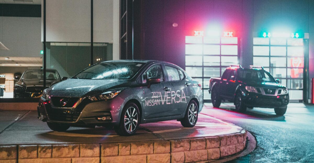 Urban showroom with luxury cars illuminated by neon lights showcasing modern vehicles at night