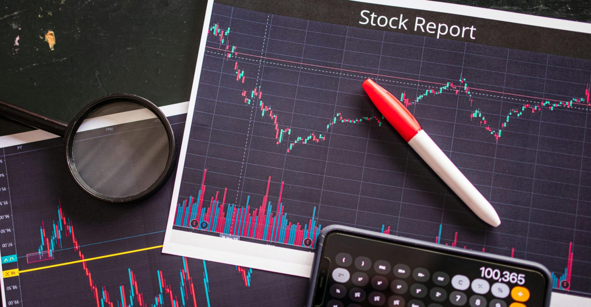 Stock report with charts, calculator, and magnifying glass for financial analysis.