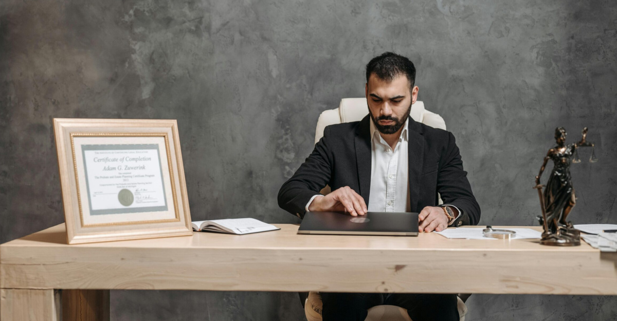 A bearded lawyer working at his office desk, showing professionalism and expertise.