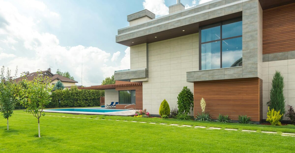 Sleek modern house with swimming pool and lush lawn perfect for luxury living