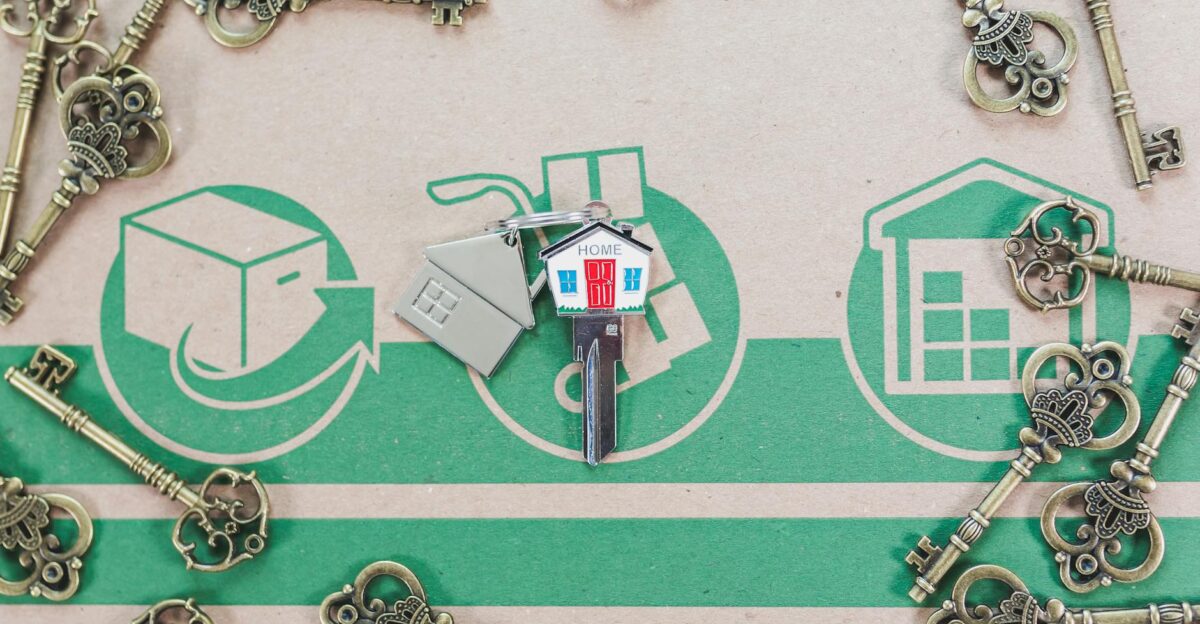A collection of vintage keys with a modern house key symbolizing real estate investment