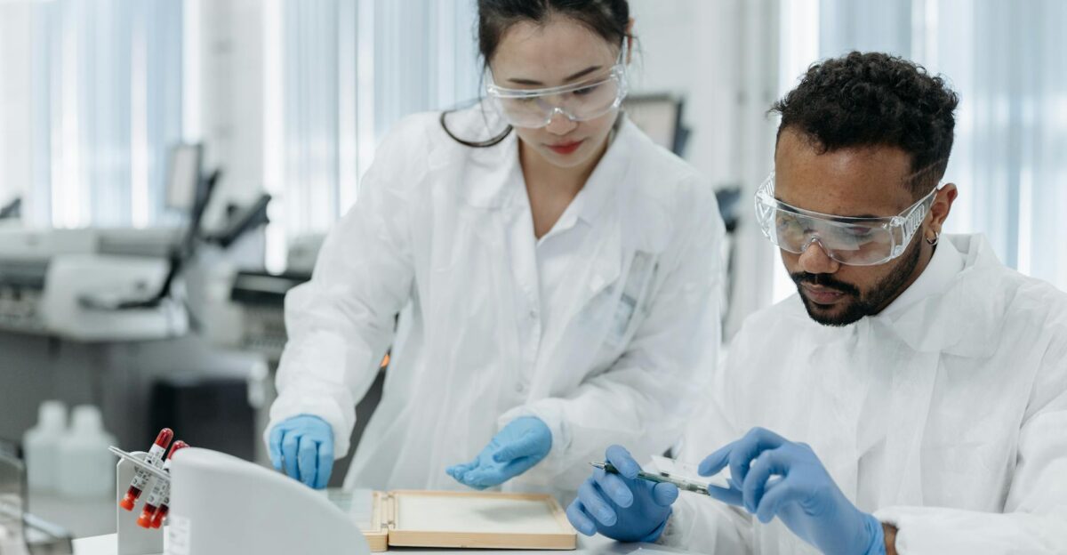 Two scientists working in a laboratory examining samples with precision and care