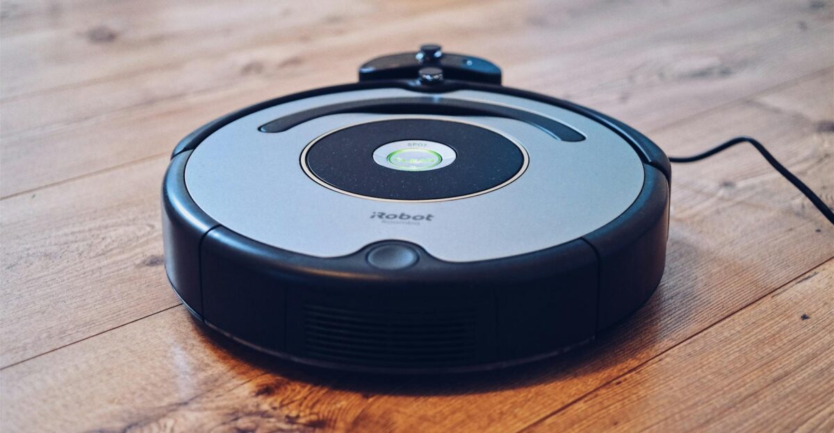 Close-up of a robotic vacuum cleaner operating on a hardwood floor showcasing modern cleaning technology