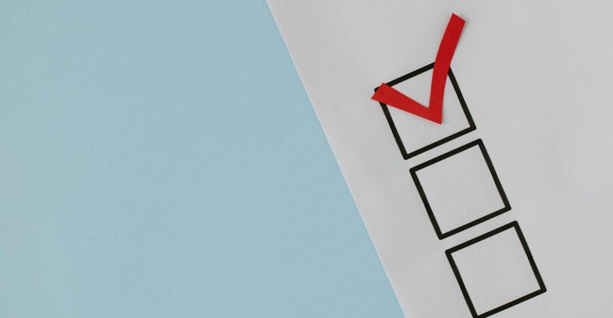 A simple white paper checklist with one red checkmark ideal for concepts like completion or approval