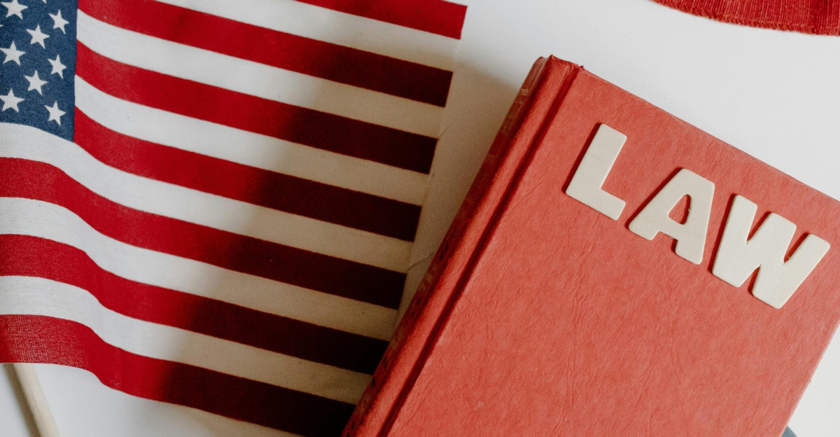 Patriotic scene with American flag and law book on a white background, symbolizing freedom and democracy.