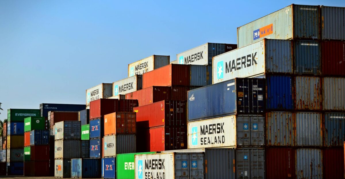 Colorful stacked shipping containers at a port exemplify global logistics
