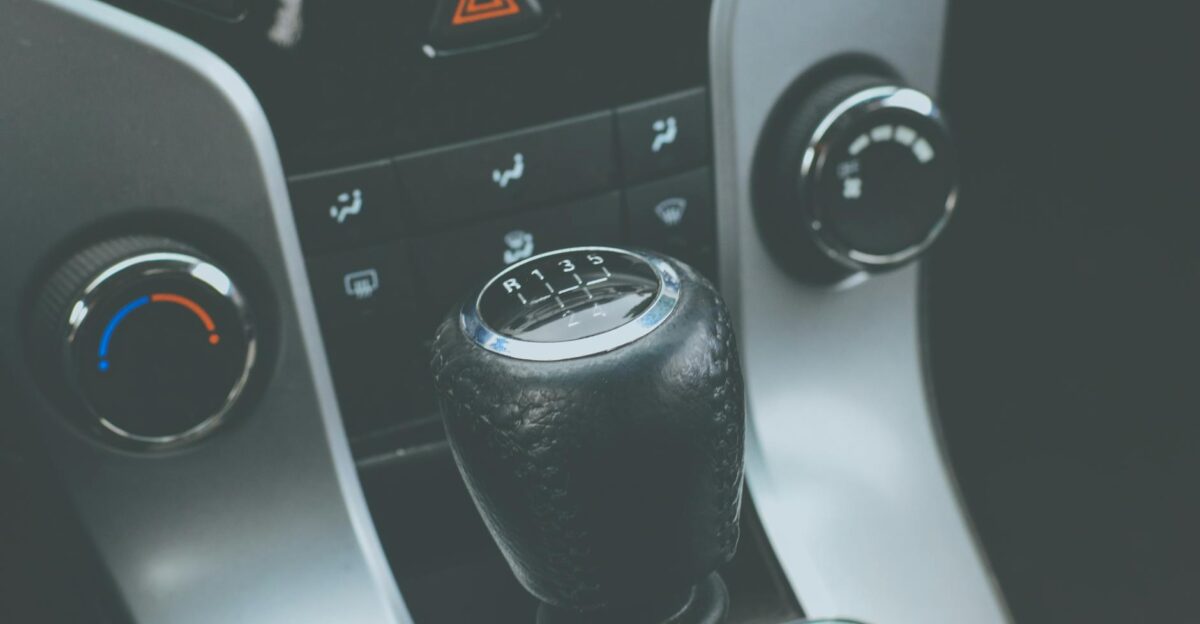 Detailed view of a manual gear shift knob and car console interior
