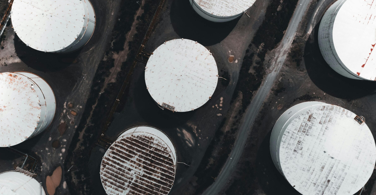 Drone shot showcasing large industrial storage tanks from above.