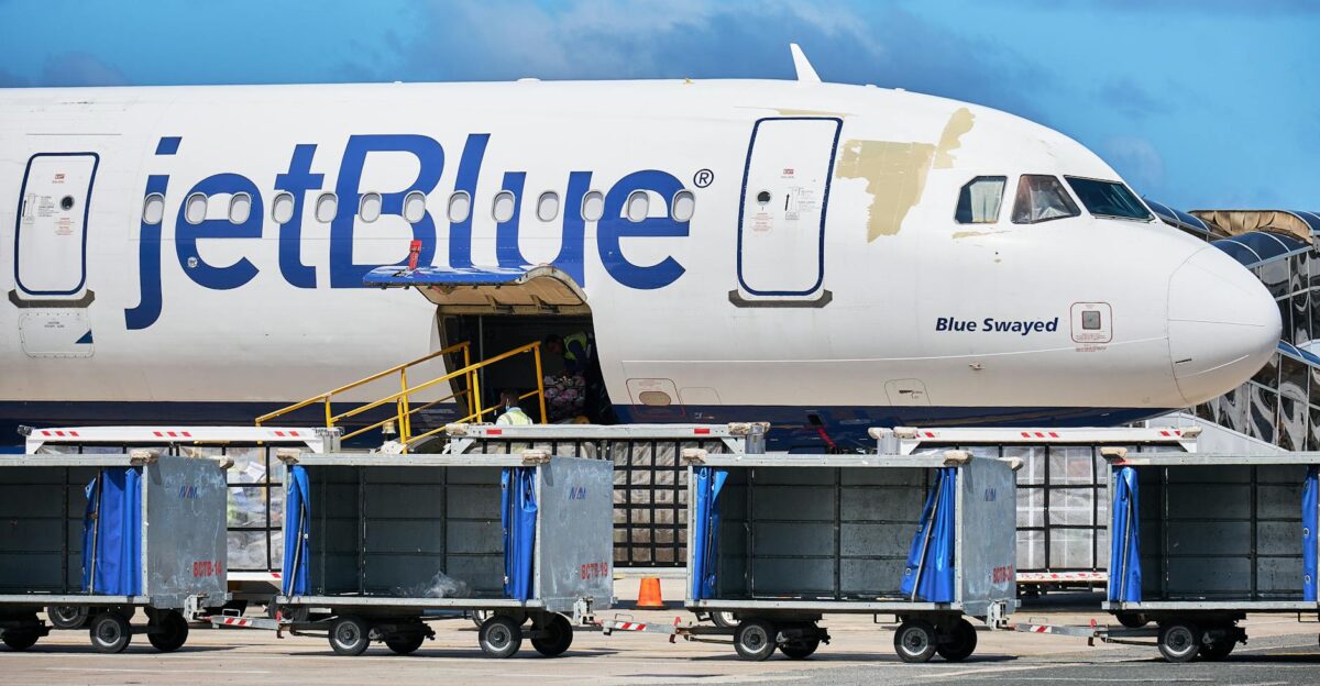 JetBlue Airbus with luggage carts at Punta Cana Airport Dominican Republic