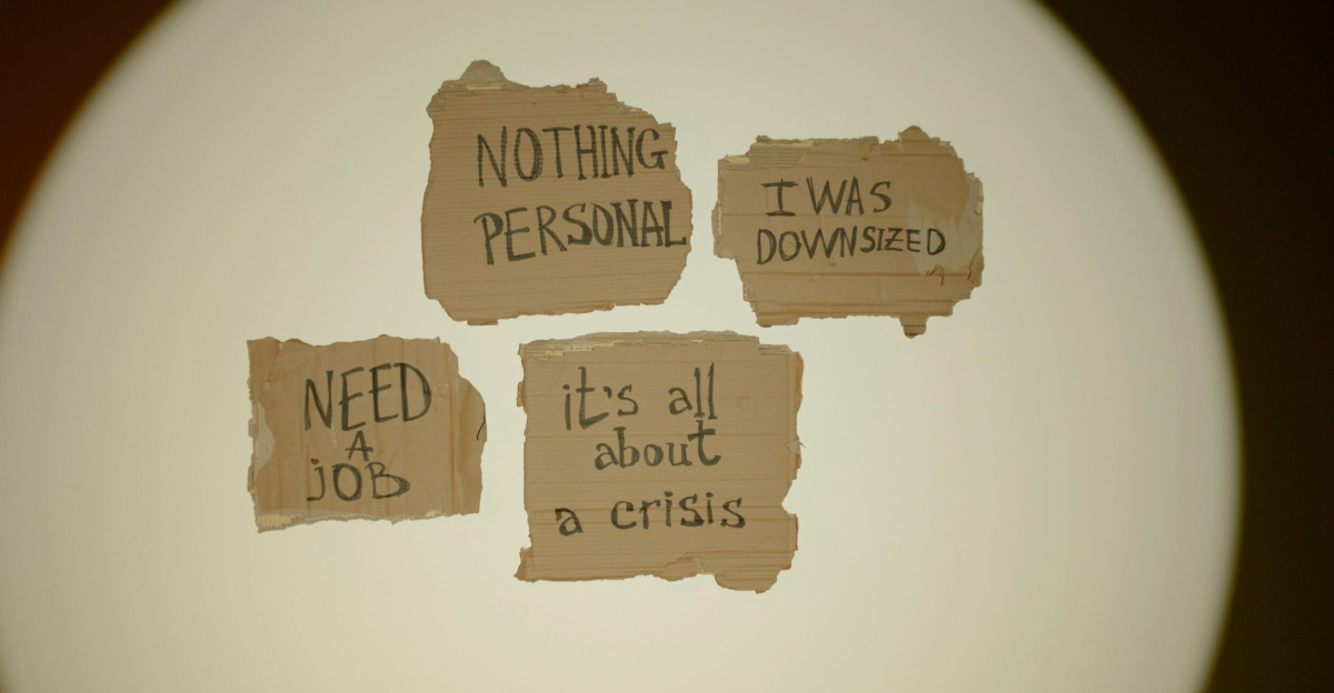 Cardboard signs convey job loss and economic crisis message, ideal for articles on unemployment.