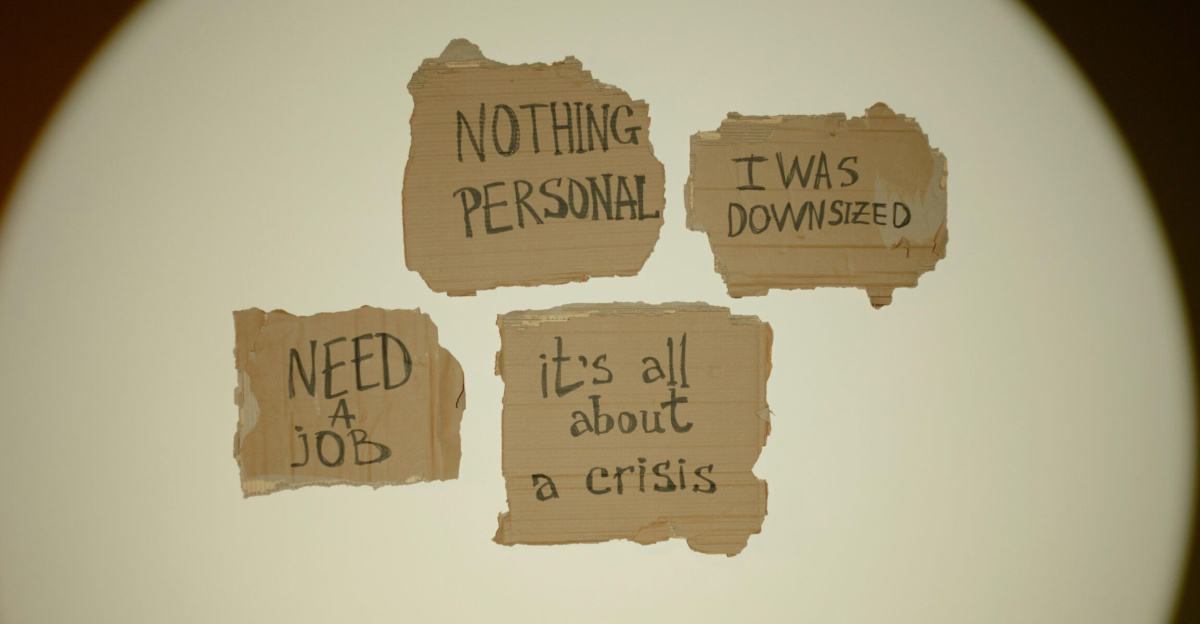 Cardboard signs convey job loss and economic crisis message, ideal for articles on unemployment.