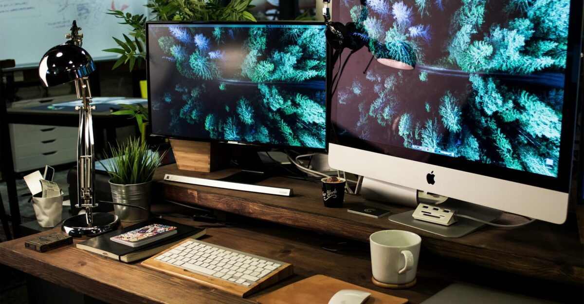 two computer monitors turned on with the same wallpaper