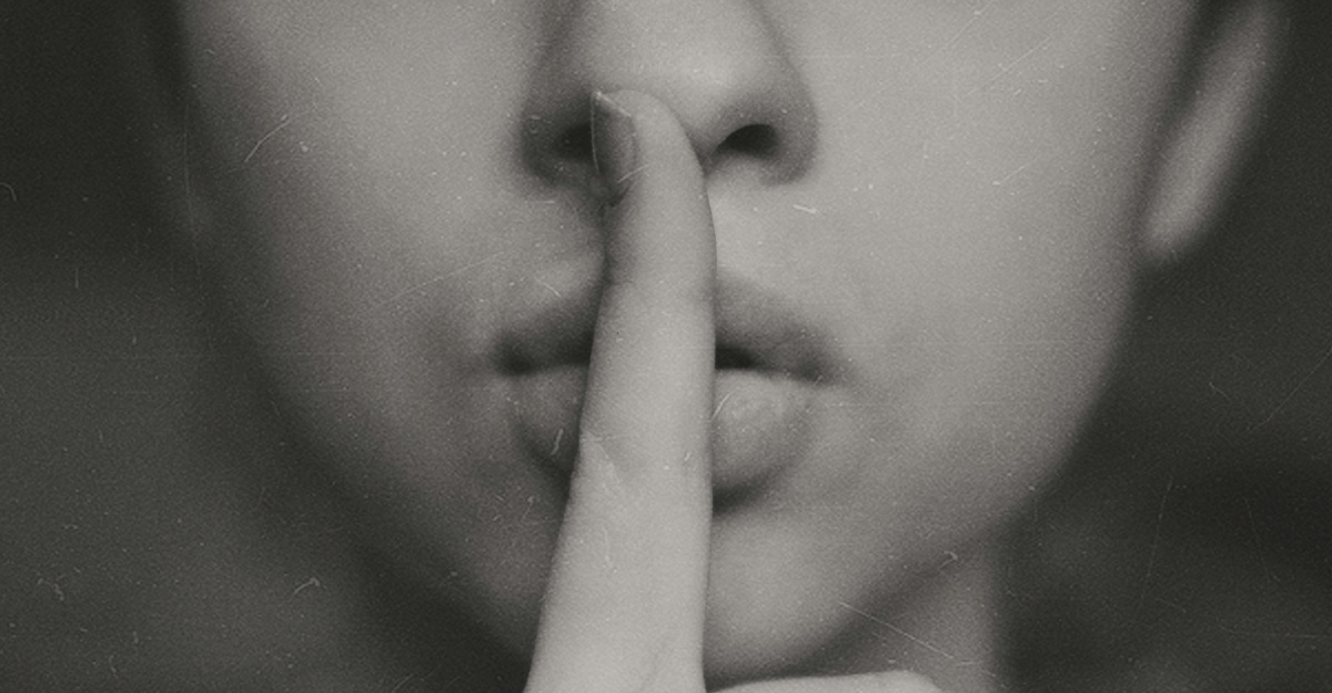 grayscale photo of woman doing silent hand sign