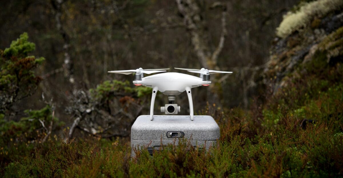white and gray DJI Phantom drone on gray box
