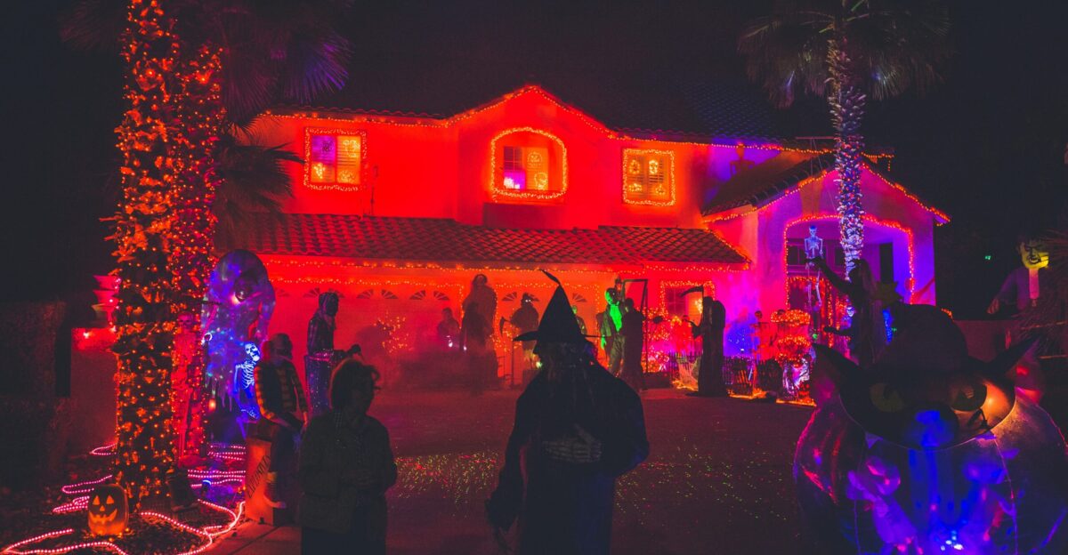 people standing near house with red light decor during night time