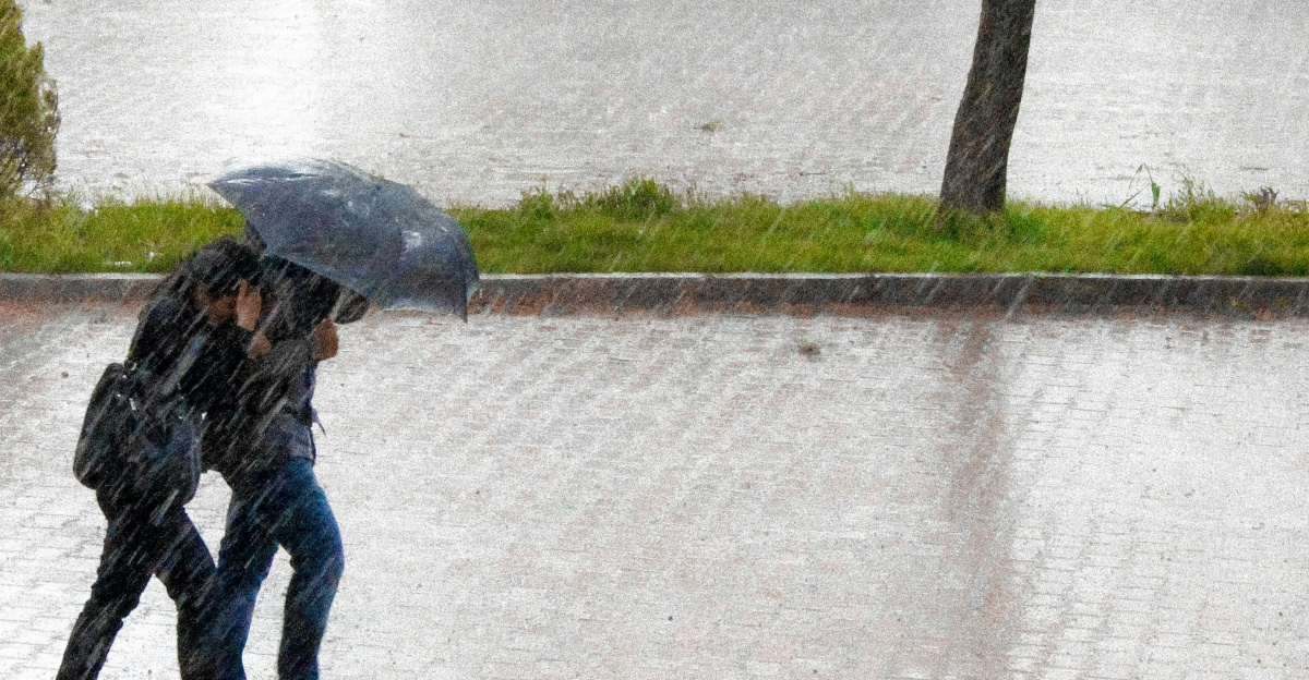 coupe walking in street while raining