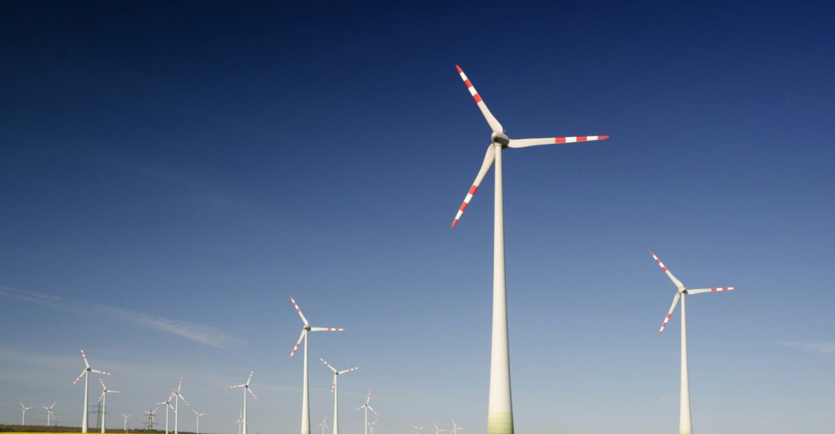 windmills on grass field at daytime